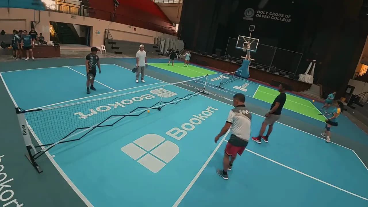 Players around the net on a Bookort pickleball court